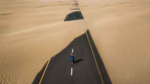 bird s eye view photography of road in the middle of desert